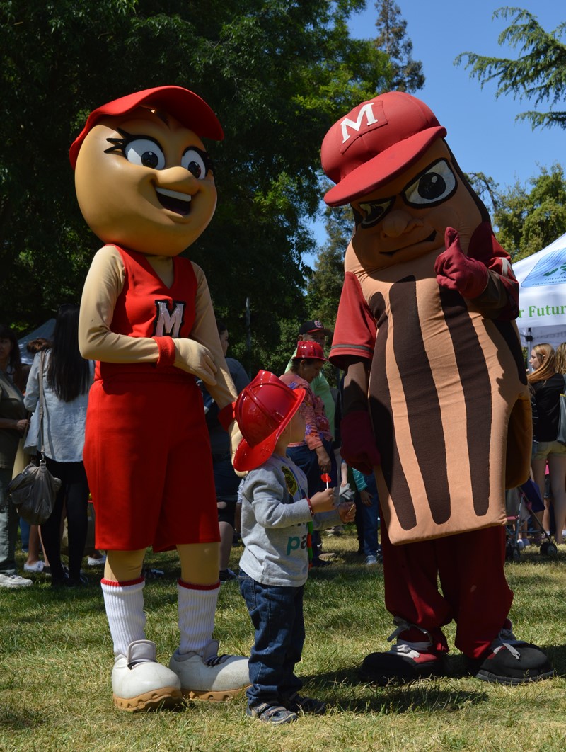 Mascots Teach a Small Child During the Earth Day E